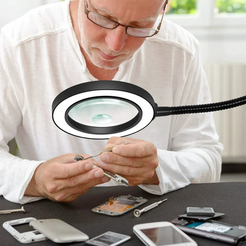 Man using LED Magnifying Lamp With Flexible Gooseneck 5X And 10X Lenses 3 Color Modes Soldering Helping Hands Base Station for repair work