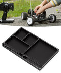 Magnetic RC Parts Tray Portable Aluminum Alloy Repair Tray With Magnetic Screw Holder Plate next to RC car repair scene