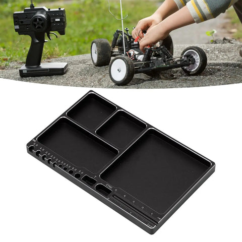 Magnetic RC Parts Tray Portable Aluminum Alloy Repair Tray With Magnetic Screw Holder Plate next to RC car repair scene