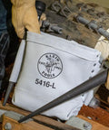 Heavy Duty Leather Five By Ten By Nine Inch Bull Pin And Bolt Bag With Tunnel Loop Connection Reinforced Bottom Ten Inch Deep Tool Pouch in use on a worksite.