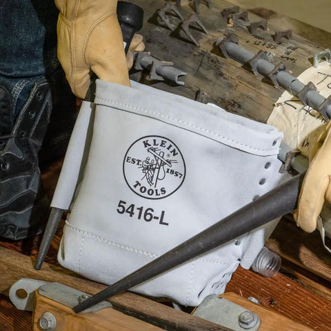 Heavy Duty Leather Five By Ten By Nine Inch Bull Pin And Bolt Bag With Tunnel Loop Connection Reinforced Bottom Ten Inch Deep Tool Pouch in use on a worksite.
