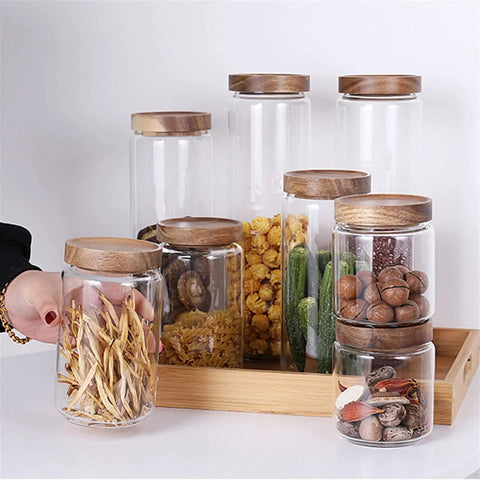 Straight Up Solid Airtight Coffee And Tea Storage Canister With Smooth Wood Lid showcasing multiple clear glass jars with snacks.
