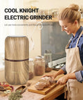 Electric Herb Grinder With Large Capacity And High Rotating Speed For Spices And Herbs Grind 120g In 5 To 10 Seconds One Hand Operation With Visual Lid For Coarse To Fine Grinding Wood Grain Finish Fast And Easy Kitchen Gadget on kitchen counter next to smiling person slicing bread.