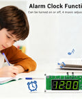 Boy writing near 4-Digit DIY Digital Clock Kit With Acrylic Shell, Adjustable Brightness LED Display showing alarm options.