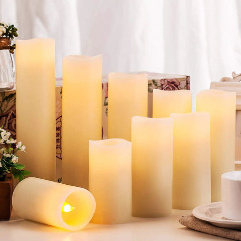 Flameless Wax Pillar Candles Set With Remote And 24 Hour Timer Battery Operated LED Candles Ivory 9 Pack In Heights 4 To 9 Inches 2.2 Inch Diameter Real Wax Look Cozy Home Vibe Decor displayed on a table