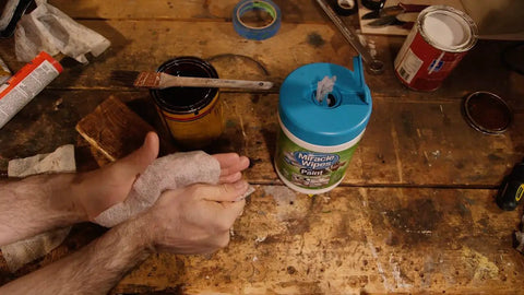 Hands using Paint Prep And Cleanup Wipes That Wipe Away Wet Paint Caulking Epoxy And Colorant From Hands Surfaces And Tools Fast