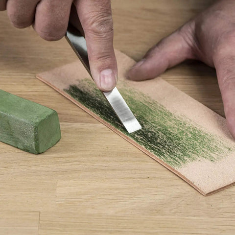 Applying honing compound from All In One Pro Grade Diamond Sharpening Kit With 180 600 And 300 1000 Grit Diamond Stones to leather strop.