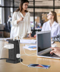 Office desk with Beefy Power Strip Tower with USB Ports and Surge Protector 12 Outlets 10 Ft Extension Cord connected to laptop and phone