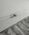 Hella Durable Acrylic Round Grab Handle With Rock Solid Metal Brackets Straight Up Secure Indoor Outdoor Wall Mount Safety Railing installed on wall near marble stairs.