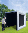 Person using Inflatable Golf Simulator Tent Enclosure For Indoor Outdoor Practice, Portable Hitting Cage With Screen, outdoors.