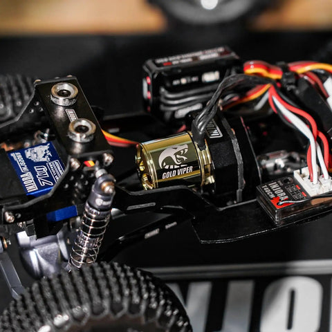 Gold Viper 1721 Brushless Motor 2800KV For One Twenty Four SCX24 Upgrade visible in a miniature RC car setup