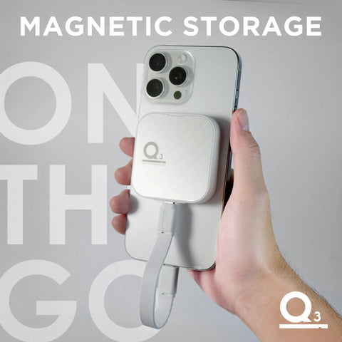 Person holding iPhone 15 Pro Max with Magnetic External SSD 1TB for on-the-go storage with MagSafe attachment.