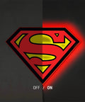 Superman Table Lamp And Night Light With Luminescent Halo, 3D S Shield Crest Wall Light Mountable shown half off half on with glow