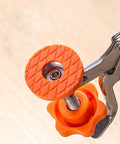 Woodworking hinge-boring guide wheel, orange 35mm, mounted on metal drilling clamp (close-up view)