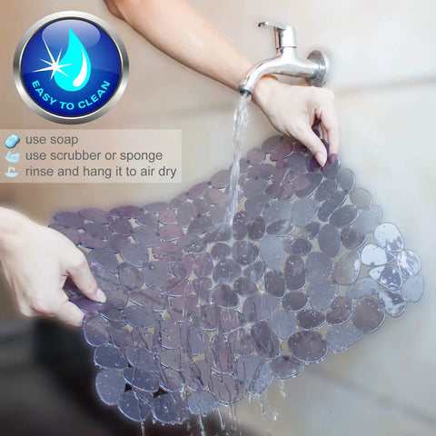 Person rinsing Pebble Sink Mat 2 Pack For Stainless Steel And Ceramic Sinks, PVC Dish Drying Mats with water, easy to clean feature displayed.