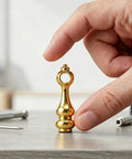 Hand holding a decorative piece from Golden Zinc Alloy Shelf Rail Brackets Set 24 Pieces With Enhanced Stability To Prevent Unwanted Movement
