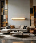 Modern Linear Alabaster Wall Sconce Featuring Polished Copper Base And Three Switchable Color Modes For Chill Bedroom And Living Room Super Sleek Bar Lamp Fixture above a cozy sectional couch.
