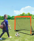 Child walking towards 2 Pack 4 Ft By 3 Ft Portable Kid Soccer Goals For Backyard Indoor And Outdoor Pop Up Play In Orange Easy Setup Sturdy Trapezoidal Frame With Ground Spikes And Includes Storage Bags