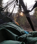 View from inside No-See-Um Hammock Mosquito Net XL 11FT By 4.6FT with 360 Degree Bug Protection, showing polyester mesh in a camping setup