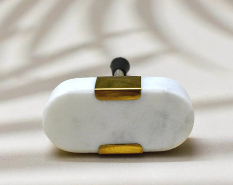Close-up of Oval Stone and Brass Knob Set for Drawers and Cabinets 1.5 inch natural stone with gold brass mount.