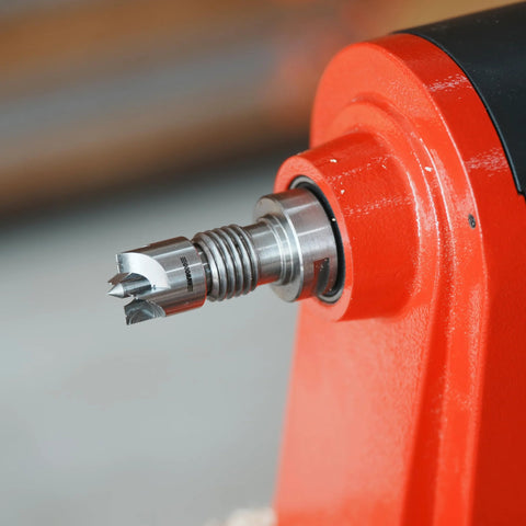 Close-up of BMWOOD 4-prong spring-loaded spur drive center mounted in red wood lathe spindle, 2MT, 1-inch diameter.