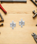 Concealed 43mm Zinc Alloy Hinges Set for Jewelry Boxes and Cabinets, four-piece cross folding hidden hinges displayed on a wooden surface.
