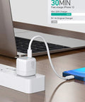 Close-up of Go To Universal Travel Adapter Charger Europe To USA Plug Converter, connecting smartphone and laptop to power strip