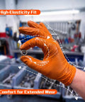 Heavy Duty 10 Mil Nitrile Gloves With Diamond Grip Latex Free Chemical Resistant Orange Disposable Mechanic Gloves For Oil, Automotive And Industrial Work Extra Large showing elasticity and grip on a nut.