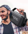 Man carrying Beast Bluetooth Speaker for Outdoors 100W Peak Power IPX6 Waterproof Boombox on his shoulder.