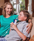 Child using New Classic Handheld Personal Steam Inhaler Vaporizer And Humidifier, mom seated next to him, providing drug-free relief.
