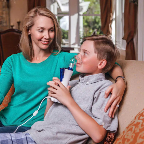 Child using New Classic Handheld Personal Steam Inhaler Vaporizer And Humidifier, mom seated next to him, providing drug-free relief.