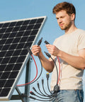Man connecting All-In-One 7-In-1 Solar Panel Adapter Kit With 3.6 Ft 12AWG MC4 Cable To DC 8mm XT60 And Anderson Connectors to a solar panel.