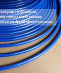 Close-up of flexible blue Quarter Inch Polyethylene Tubing for RO Water Systems coiled on surface