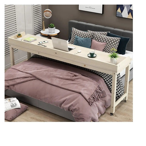 Roomy Rollin Overbed Laptop Desk Featuring Sturdy Guard Rail And Smooth Lockable Wheels Solid Wood Bedside Tray, placed on bed with laptop.