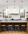 Lumraxsun Vintage Pendant Light Over Kitchen Glass Kitchen Pendant Light hanging above a modern kitchen island with wooden stools.