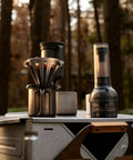 Kick Up Your Daily Brew Game With This Portable Electric Coffee Grinder Featuring 45 Precision Settings And Stainless Steel Conical Burrs A Straight Up Game Changer For Espresso Pour Over Drip Or Cold Brew Creations All Day, showcasing coffee brewing setup outdoors with grinder.