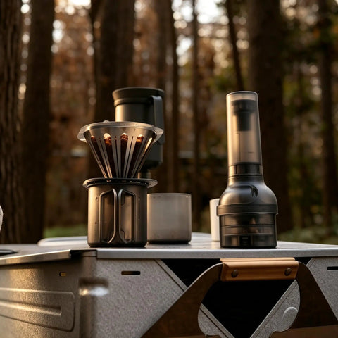 Kick Up Your Daily Brew Game With This Portable Electric Coffee Grinder Featuring 45 Precision Settings And Stainless Steel Conical Burrs A Straight Up Game Changer For Espresso Pour Over Drip Or Cold Brew Creations All Day, showcasing coffee brewing setup outdoors with grinder.
