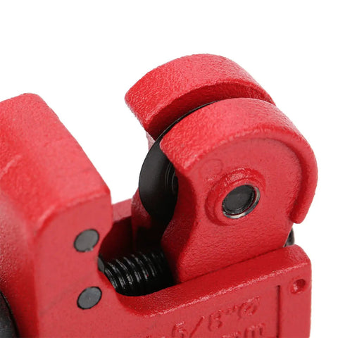 Close-up of red Compact Tube Cutter With Ball Bearing Roller 3 to 16mm Capacity, showing detailed cutting mechanism.