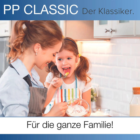Mother and daughter enjoying dessert together in a kitchen, showcasing a joyful family moment.