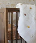 Traditional Paste The Wall Safari Nursery Wallpaper With Watercolor Lions Elephants And Giraffes Print In Neutral Jungle Tones For Baby Rooms Cozy Neutral Decor 20.87 Inch By 270 Inch Roll behind crib with polka dot blanket