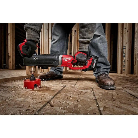 Worker using M18 FUEL 18V Brushless Cordless Gen 2 Super Hawg One Half Inch Right Angle Drill Tool Only for wood drilling on floor