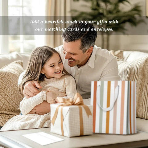 Father and daughter with All In One Gift Bag Set With Four Medium 9 Inch Bags and matching greeting cards on table