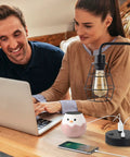Two Pack Industrial Table Lamps With Dual USB Ports And AC Outlet on desk with laptop and phone, black metal cage shade visible.