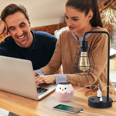 Two Pack Industrial Table Lamps With Dual USB Ports And AC Outlet on desk with laptop and phone, black metal cage shade visible.
