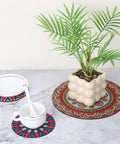 8 Pcs Boho Plant Coaster And Mat Set For Indoor And Outdoor Pots Protect Tables Desks And Floors With Round Flower Saucers In Two Sizes 12 By 12 Cm And 22 By 22 Cm displayed on marble surface with plant and dishware.
