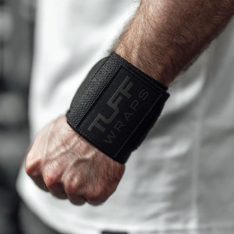 Person wearing 16 Inch Wrist Straps For Gym No Thumb Loops Durable Wrist Wraps For Powerlifting Weightlifting And Bench Press Support Strength Training Accessory For Enhanced Wrist Stability, black color.