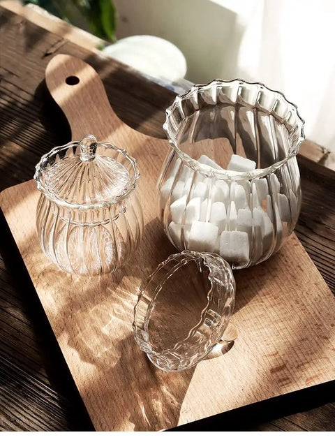 European Vertical Striped Glass Canister 420 Ml Dry Food Storage Jar Kitchen Counter with sugar cubes on a wooden tray.