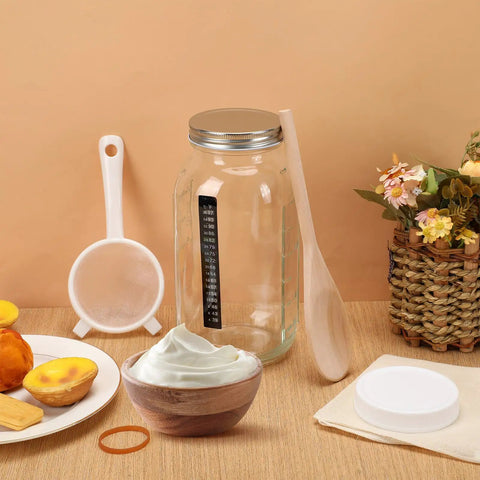 All In One Kefir And Kombucha Fermentation Kit with 64 oz wide mouth jar, plastic lid, nylon mesh strainer, and wood spoon.