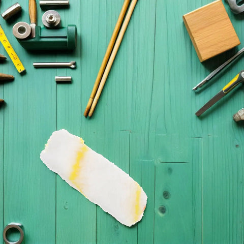 Top Tier 10 Piece Paint Roller Cover Refills For Smooth Wall And Ceiling Painting Ultra Thick Sleeves laid out on a turquoise wooden surface.