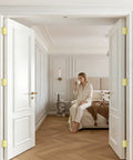 Open white door with 48 pack polished brass door hinges in bright gold finish 3 and a half inch by 3 and a half inch for interior doors